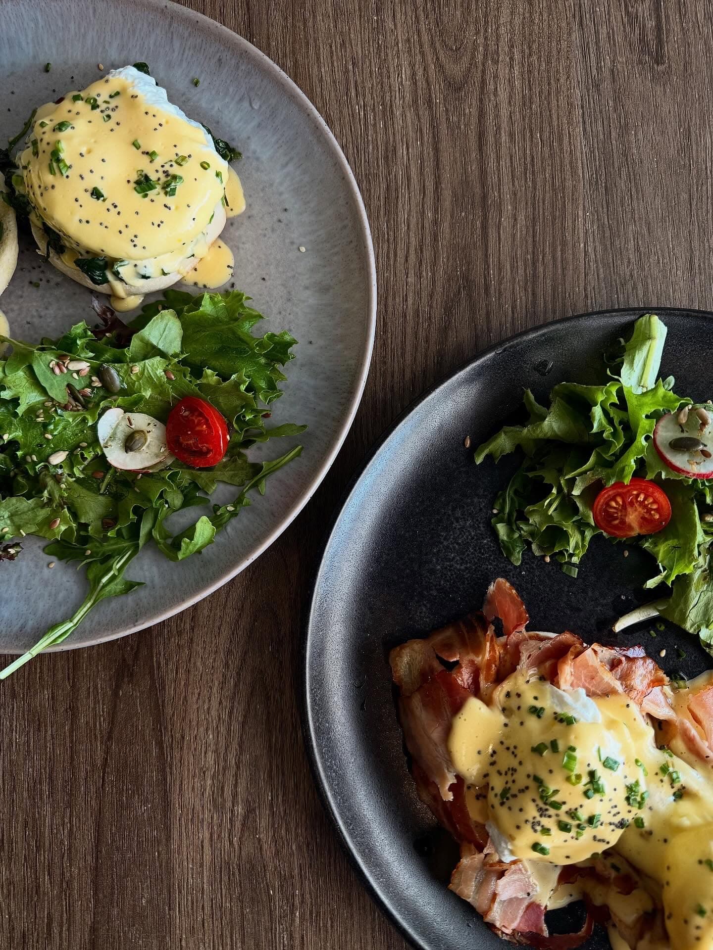 Poached eggs Florentine and Benedict with hollandaise and salad